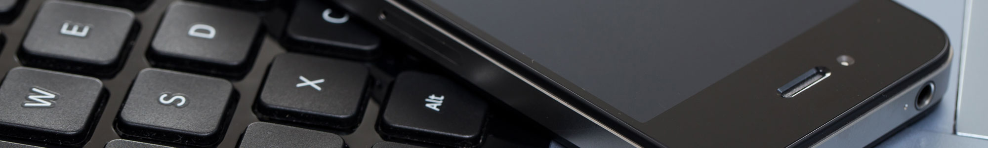 Mobile phone on laptop keyboard