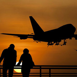 Couple watching aeroplane take off at Liverpool airport